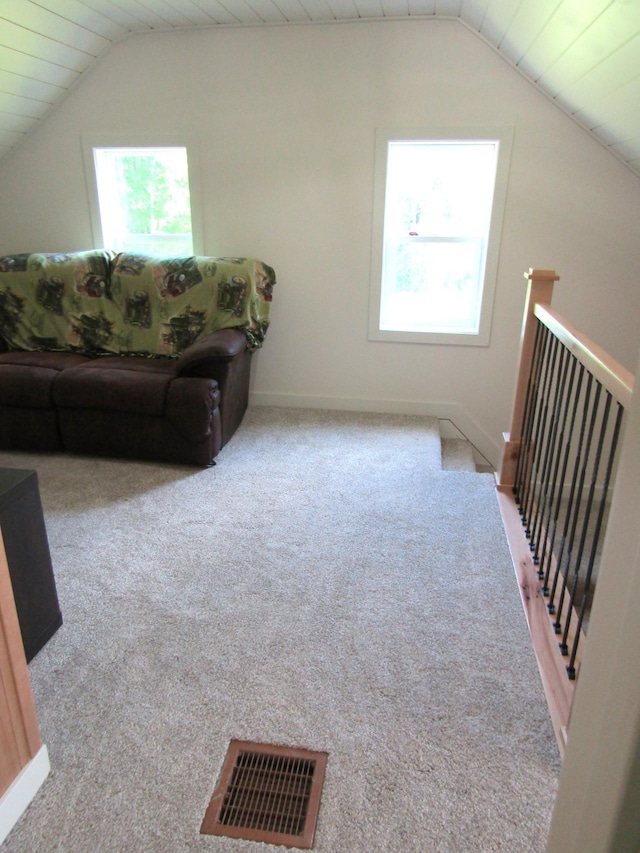 carpeted living room featuring lofted ceiling and wooden ceiling