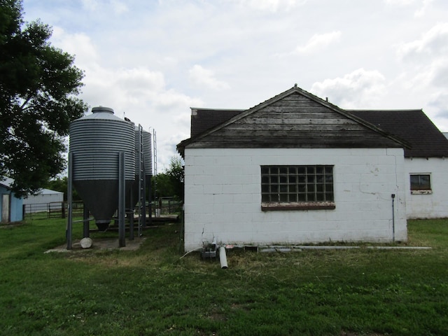 view of property exterior with a lawn