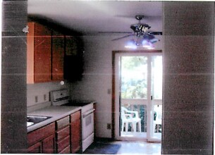 kitchen featuring electric range, sink, and ceiling fan