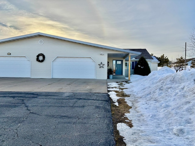 view of front of property featuring covered porch, driveway, and an attached garage