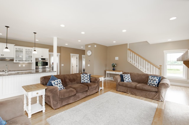 16305 57th St SE, Kindred, ND 58051 - living room with stairway, light wood-type flooring, and recessed lighting