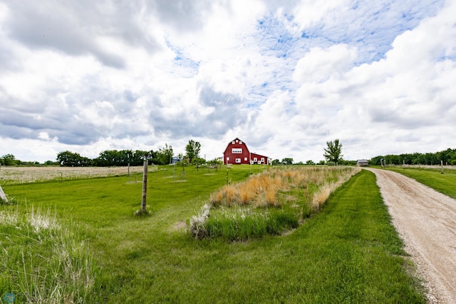 16305 57th St SE, Kindred, ND 58051 - view of dirt / gravel driveway featuring a barn and a view of rural / pastoral area