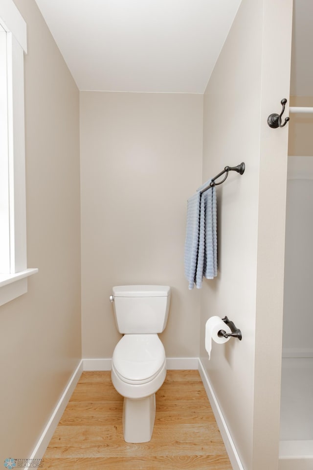 16305 57th St SE, Kindred, ND 58051 - bathroom with toilet, wood finished floors, and baseboards