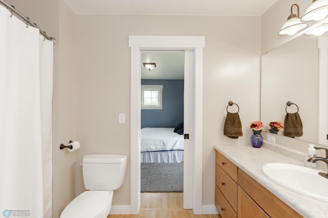 16305 57th St SE, Kindred, ND 58051 - ensuite bathroom featuring vanity, toilet, baseboards, and curtained shower