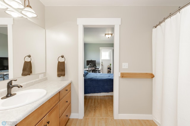16305 57th St SE, Kindred, ND 58051 - ensuite bathroom with wood finished floors, vanity, baseboards, and curtained shower