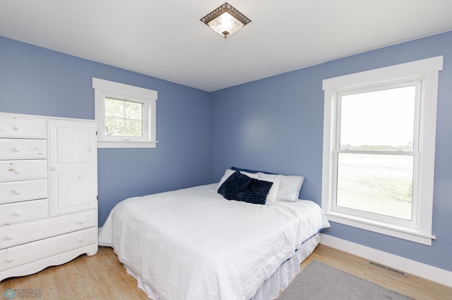 16305 57th St SE, Kindred, ND 58051 - bedroom with light wood finished floors and baseboards