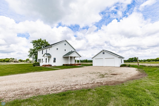 16305 57th St SE, Kindred, ND 58051 - view of side of home with an outbuilding, a yard, a garage, and driveway