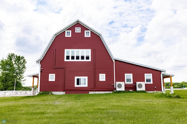 16305 57th St SE, Kindred, ND 58051 - view of property exterior featuring ac unit, a barn, a yard, and an outbuilding
