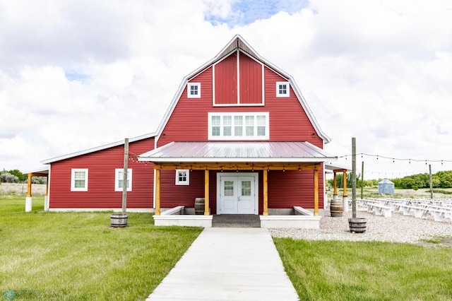 16305 57th St SE, Kindred, ND 58051 - view of front of house with a gambrel roof, a front lawn, and metal roof