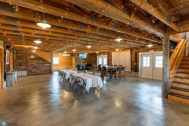 16305 57th St SE, Kindred, ND 58051 - dining room with stairway, finished concrete flooring, and wooden walls