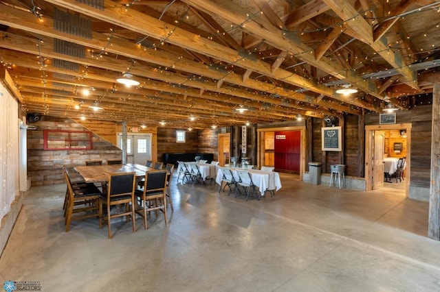16305 57th St SE, Kindred, ND 58051 - dining area featuring concrete flooring and wood walls