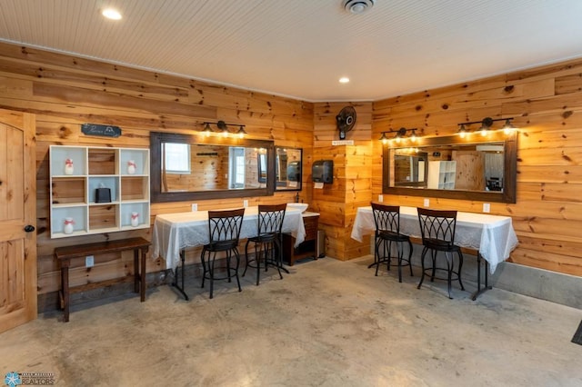 16305 57th St SE, Kindred, ND 58051 - dining space with wooden walls, unfinished concrete floors, and recessed lighting