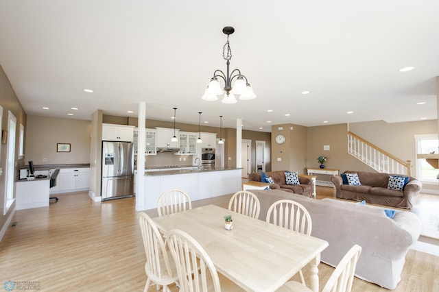 16305 57th St SE, Kindred, ND 58051 - dining space featuring light wood-style floors, recessed lighting, stairway, and a chandelier