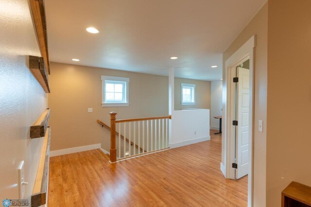 16305 57th St SE, Kindred, ND 58051 - corridor featuring an upstairs landing, wood finished floors, recessed lighting, and baseboards
