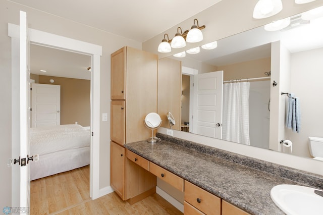 16305 57th St SE, Kindred, ND 58051 - full bathroom with wood finished floors, vanity, toilet, curtained shower, and ensuite bath
