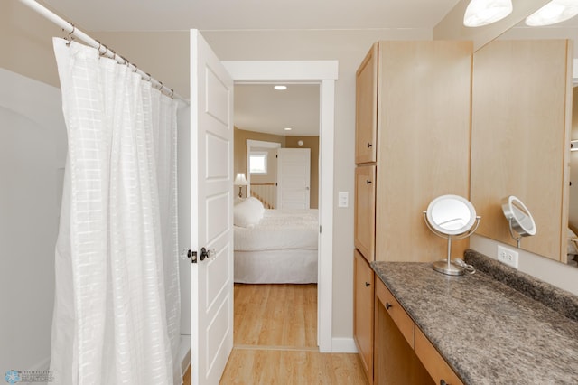 16305 57th St SE, Kindred, ND 58051 - bathroom with connected bathroom, wood finished floors, vanity, and recessed lighting