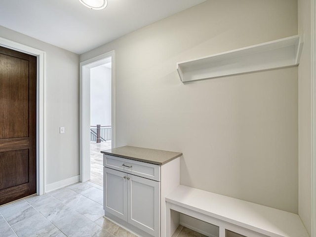 mudroom featuring marble finish floor