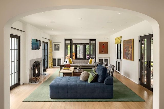 living room featuring light wood-type flooring and french doors