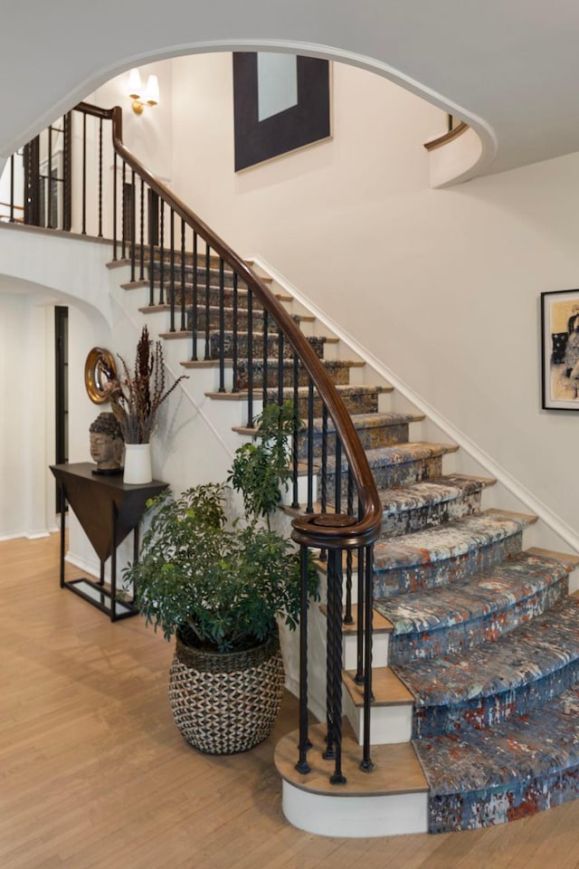 stairs featuring hardwood / wood-style floors