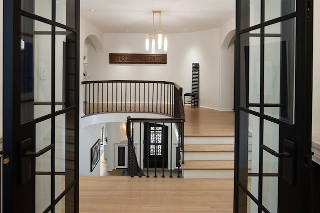 interior space featuring a notable chandelier and wood-type flooring