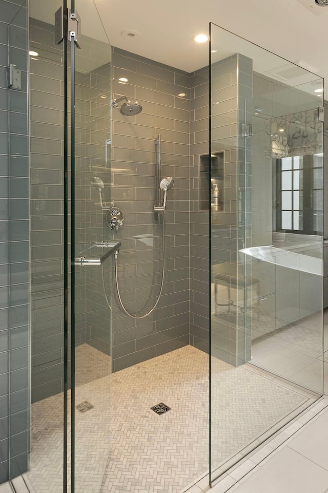 bathroom with tile flooring and a shower with shower door