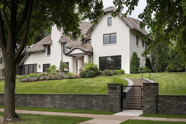 french country inspired facade with a front yard