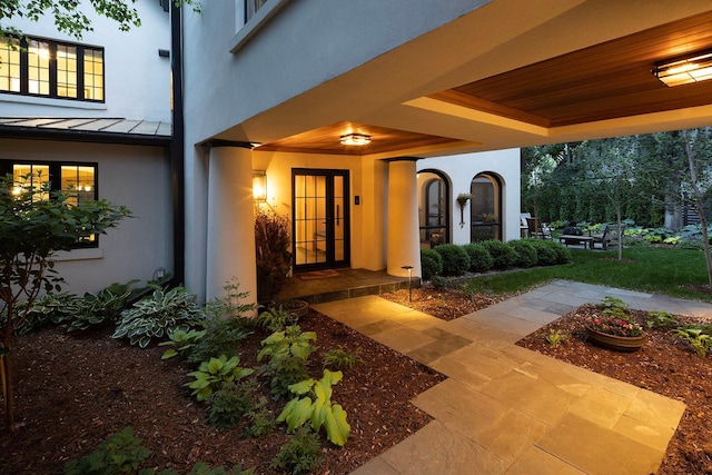 view of exterior entry with a patio