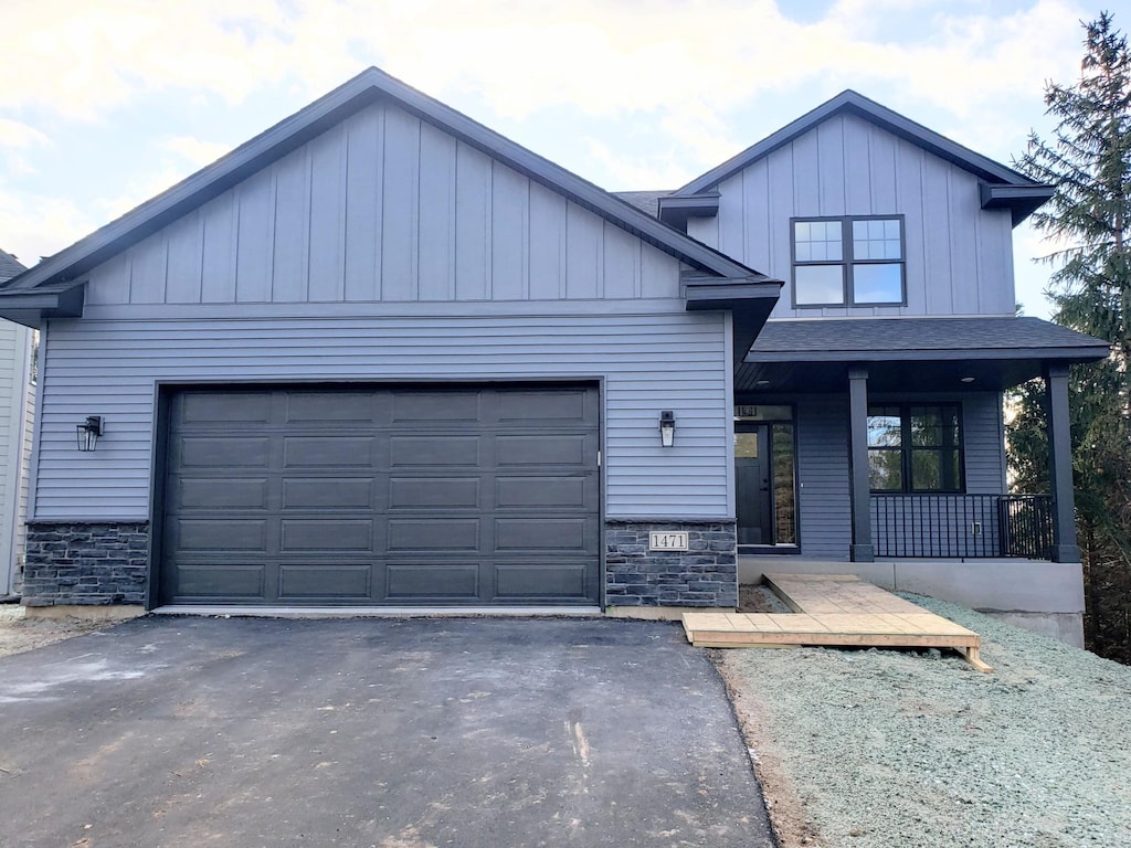 view of front of property featuring a garage and covered porch