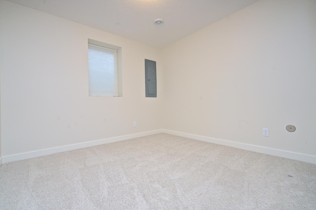 unfurnished room featuring carpet, electric panel, and baseboards