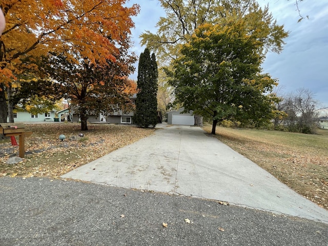 view of property hidden behind natural elements featuring a garage