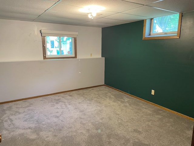 unfurnished room featuring carpet floors and a drop ceiling