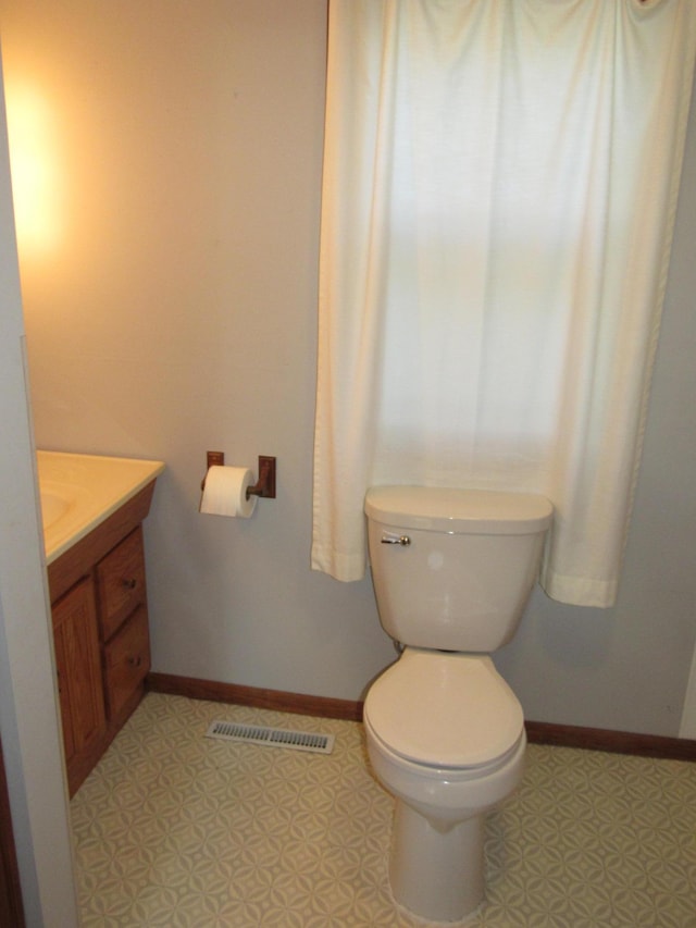 bathroom featuring vanity and toilet