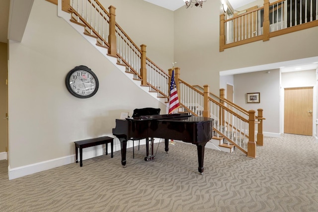 miscellaneous room with a high ceiling and carpet floors