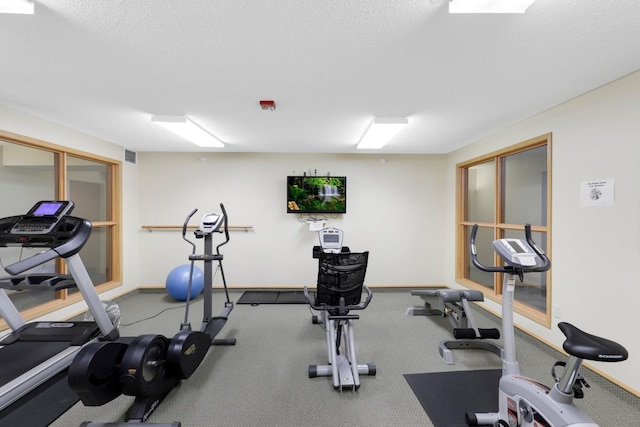 workout room featuring a textured ceiling