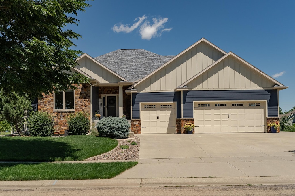 craftsman-style house with a front lawn and a garage