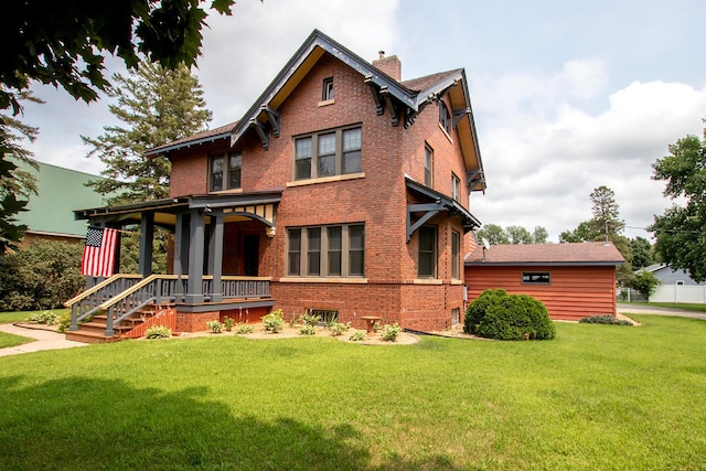 view of front of property with a porch and a front lawn