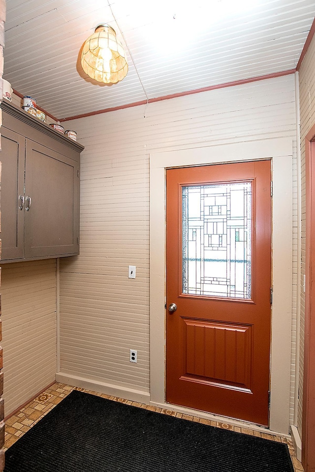 doorway to outside featuring brick wall