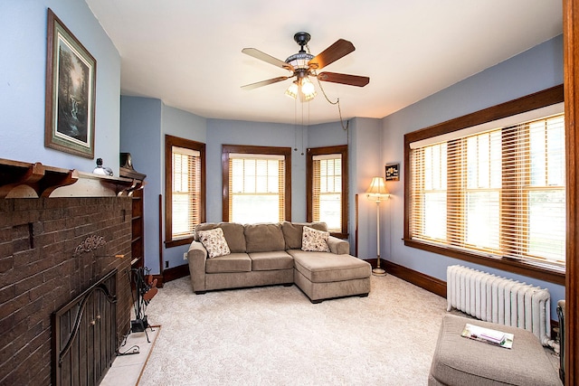 living room with radiator, ceiling fan, light colored carpet, and a wealth of natural light