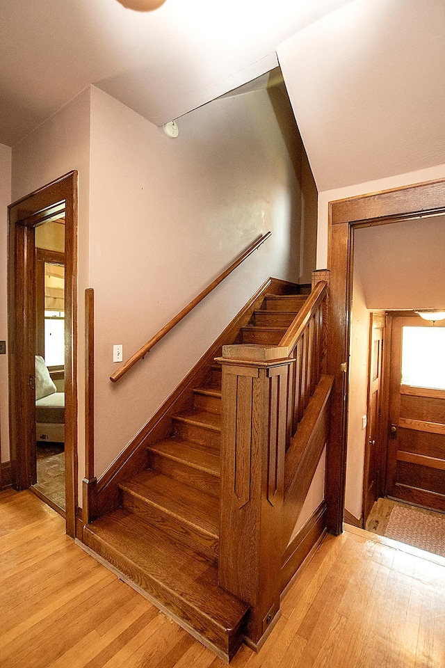 stairs featuring hardwood / wood-style floors