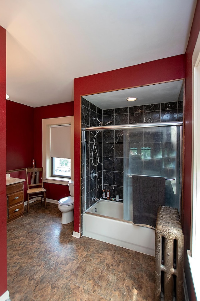 bathroom with enclosed tub / shower combo and toilet