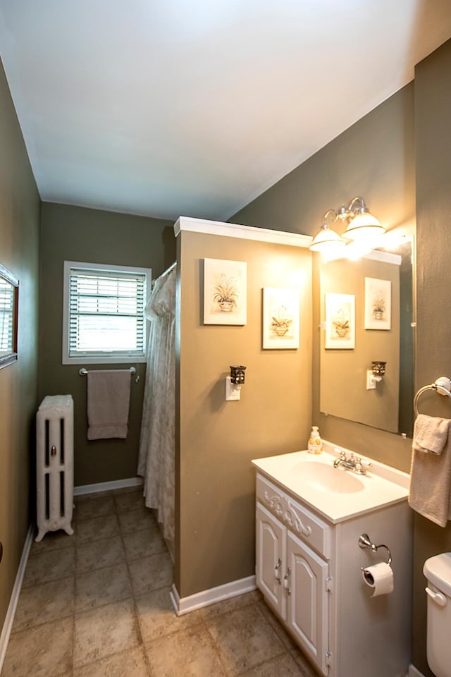 bathroom featuring radiator heating unit, curtained shower, vanity, and toilet