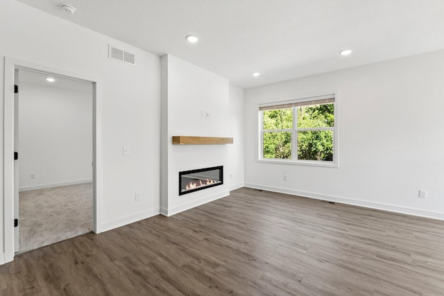 unfurnished living room featuring dark hardwood / wood-style flooring