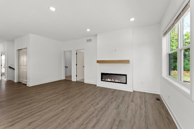 unfurnished living room with dark wood-type flooring