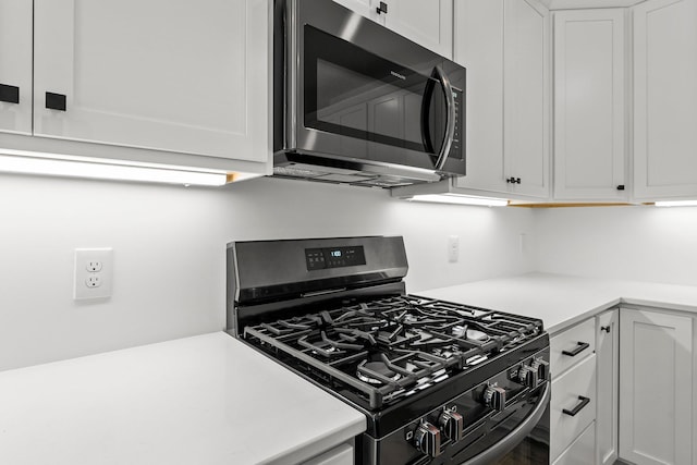 kitchen with appliances with stainless steel finishes and white cabinetry