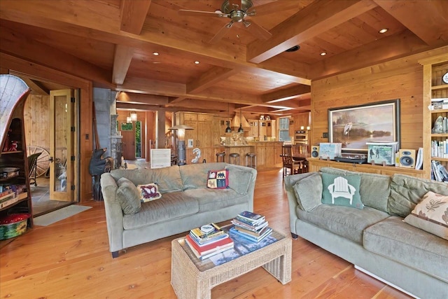 living room with ceiling fan, wood ceiling, light hardwood / wood-style flooring, and wood walls