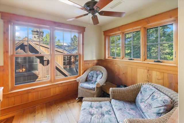 sunroom featuring ceiling fan