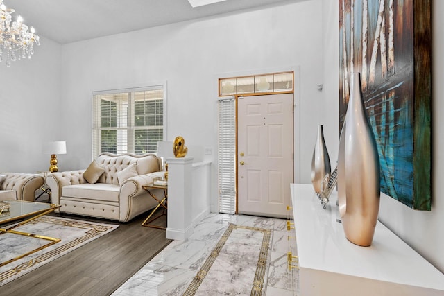 foyer featuring an inviting chandelier and light hardwood / wood-style flooring