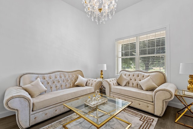 living room with an inviting chandelier and dark wood-type flooring