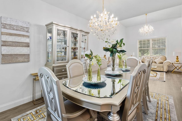 dining space featuring a notable chandelier and dark hardwood / wood-style floors