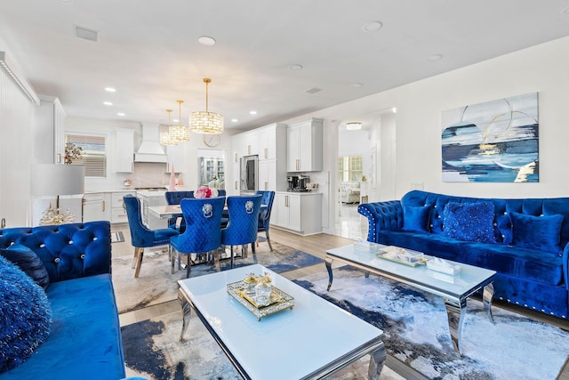 living room featuring an inviting chandelier and light hardwood / wood-style flooring